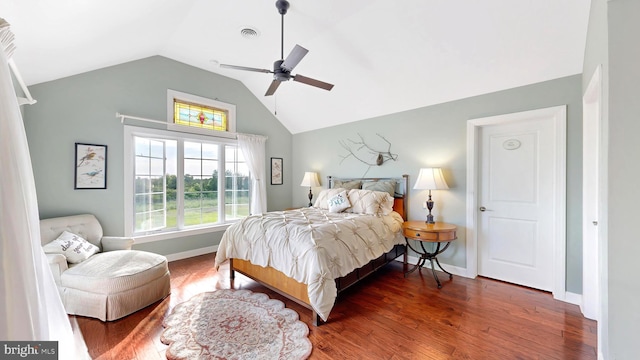 bedroom with ceiling fan, dark hardwood / wood-style flooring, and vaulted ceiling