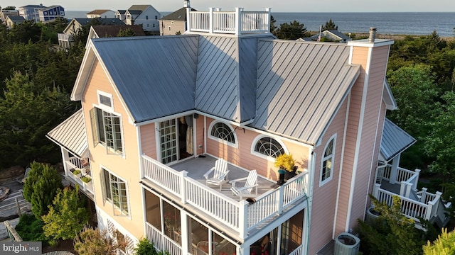 exterior space featuring central AC and a water view