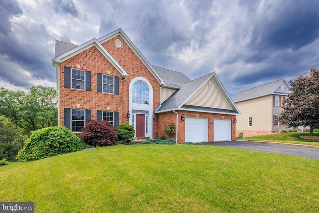 view of front facade with a front yard and a garage