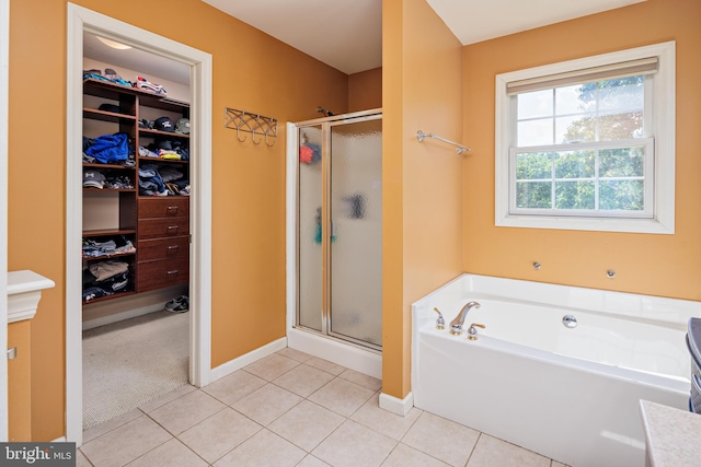 bathroom featuring plus walk in shower and tile patterned flooring