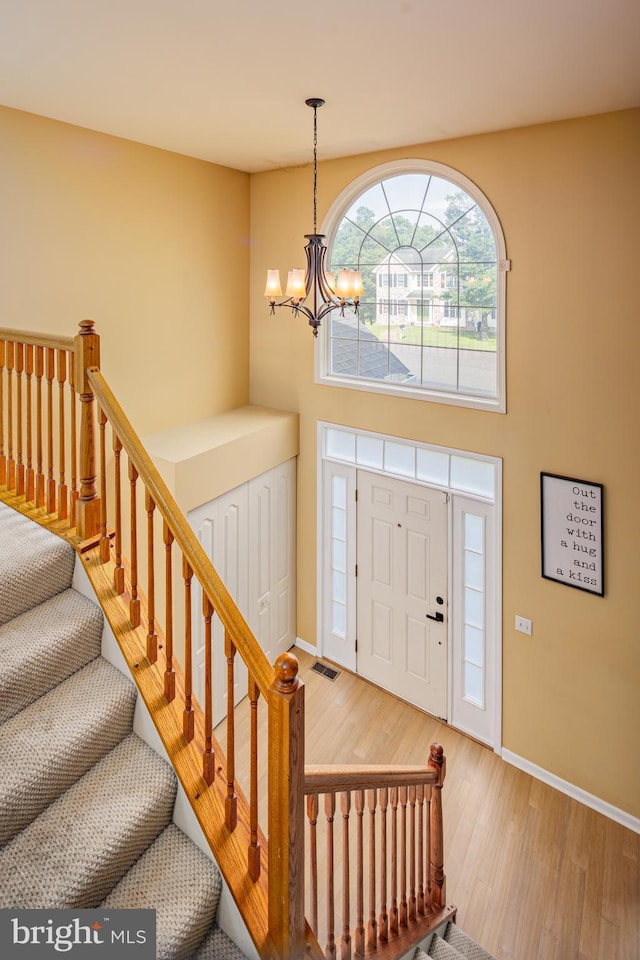 foyer featuring hardwood / wood-style flooring and an inviting chandelier