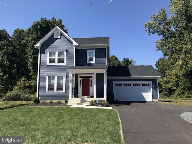 view of front facade with a garage and a front lawn