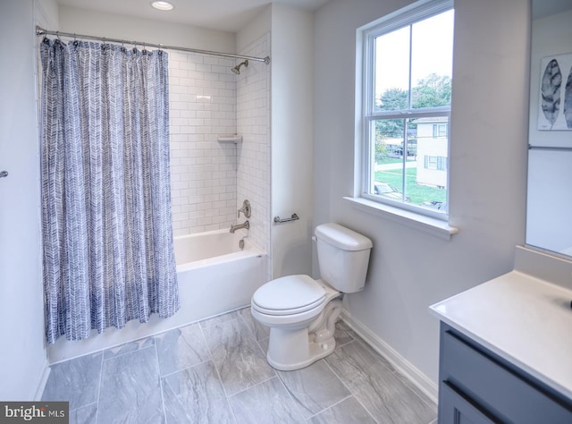 full bathroom featuring shower / bath combo with shower curtain, vanity, and toilet