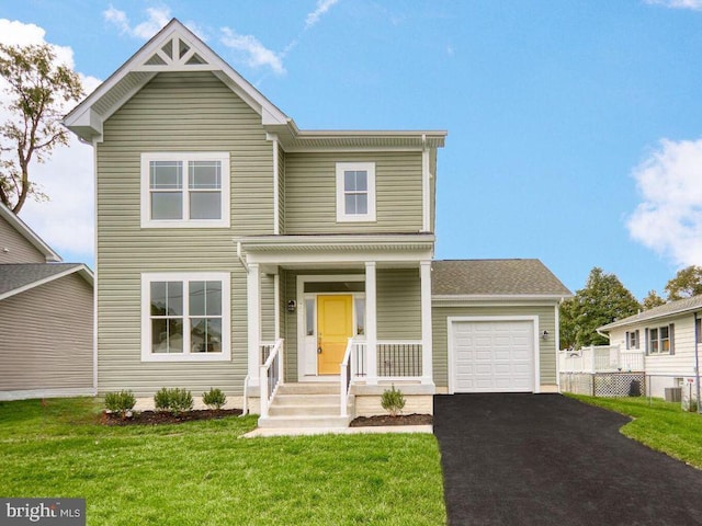 view of front facade with a front yard and a garage