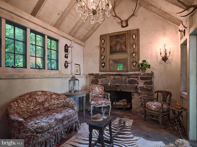 living area with a notable chandelier, a fireplace, high vaulted ceiling, and beamed ceiling