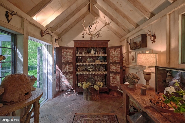 interior space featuring high vaulted ceiling and beamed ceiling