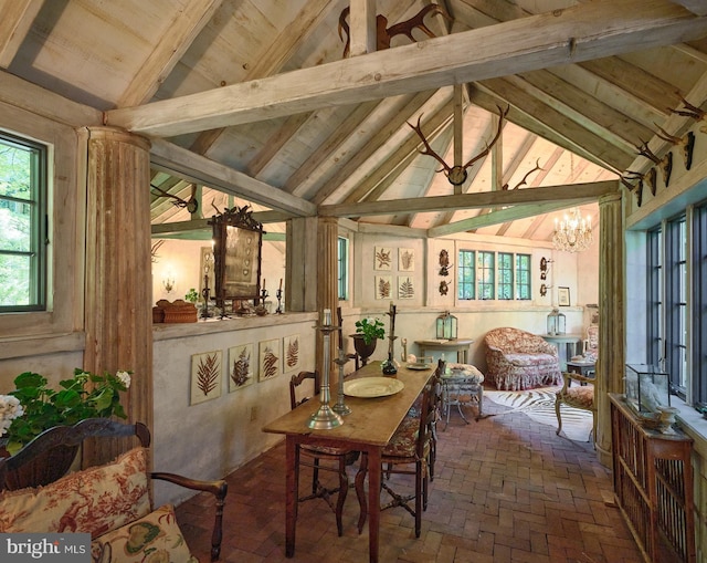 sunroom with a notable chandelier and lofted ceiling with beams