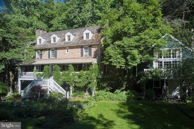 exterior space with covered porch and a yard