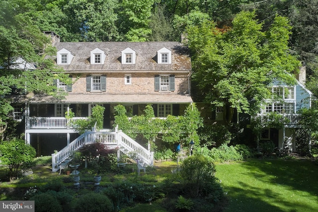 rear view of house with a yard