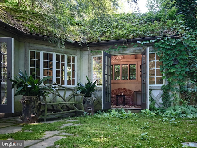 exterior space featuring french doors and a yard