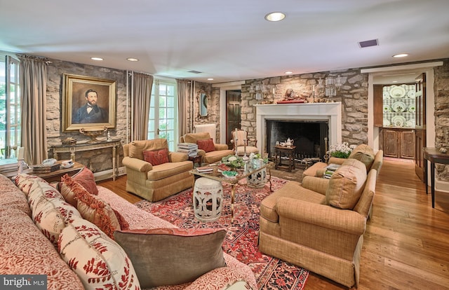 living room featuring wood-type flooring and a fireplace