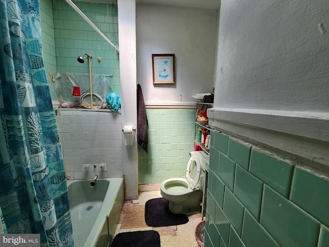 bathroom featuring toilet, shower / bathtub combination with curtain, and tile walls