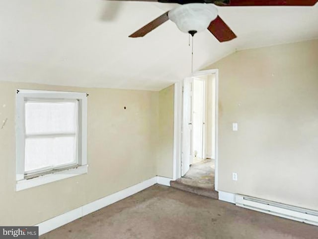 empty room with carpet flooring, a baseboard radiator, ceiling fan, and lofted ceiling