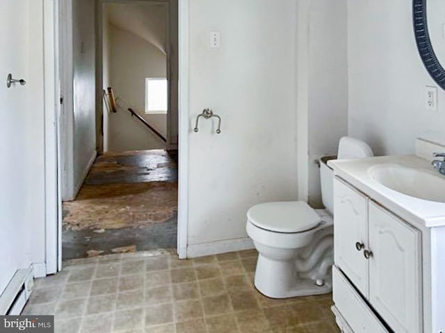 bathroom with vanity, toilet, and baseboard heating