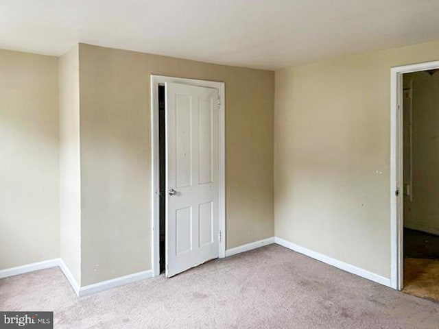 empty room with light colored carpet