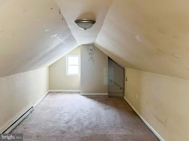 additional living space featuring light carpet, a baseboard radiator, and lofted ceiling