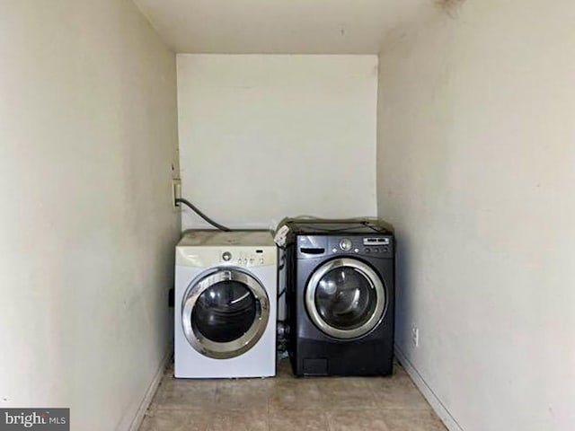 clothes washing area featuring washer and dryer