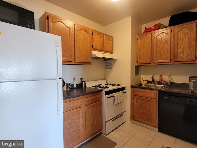 kitchen featuring sink, light tile patterned floors, and white appliances