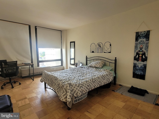 bedroom with light parquet floors