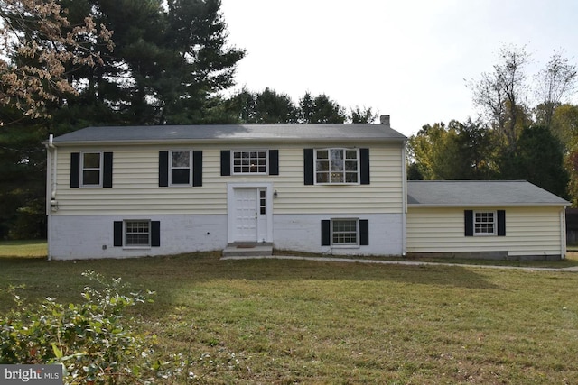 raised ranch with a front lawn