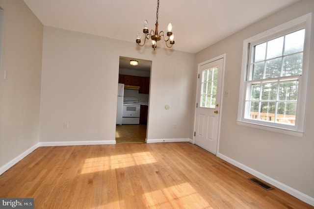 interior space featuring light hardwood / wood-style flooring and a notable chandelier