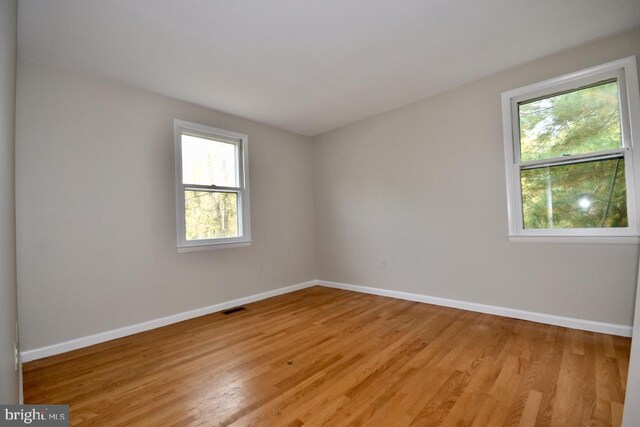 spare room with light hardwood / wood-style floors