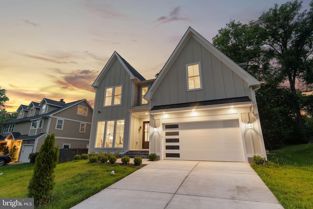 view of front of home featuring a garage and a lawn