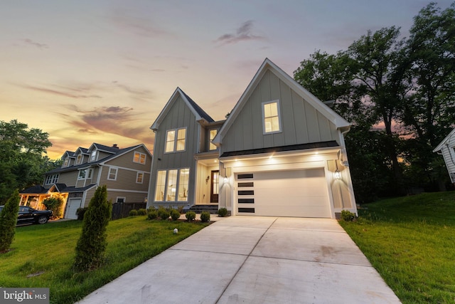 view of front of property with a garage and a lawn