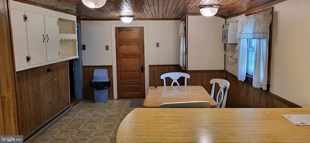 dining area featuring wood walls and wood ceiling