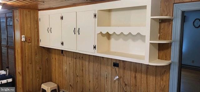 mudroom featuring wood walls