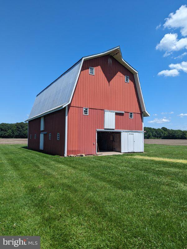 view of outdoor structure featuring a lawn