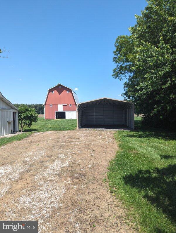 view of yard with a carport and an outdoor structure