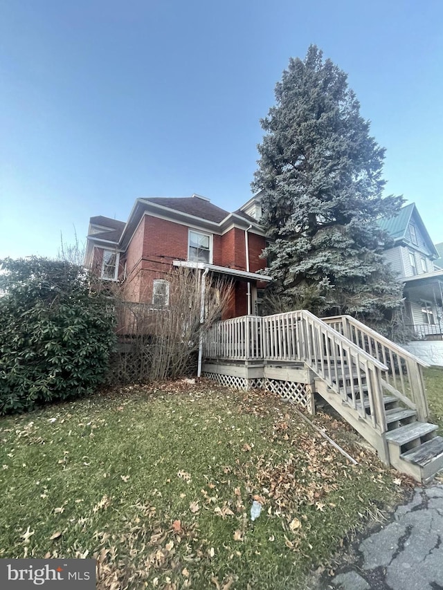 exterior space featuring a yard and a wooden deck