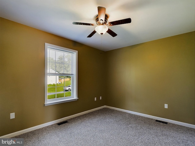 carpeted spare room with ceiling fan