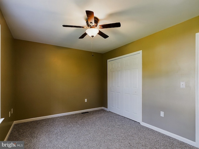 unfurnished bedroom with ceiling fan, a closet, and carpet