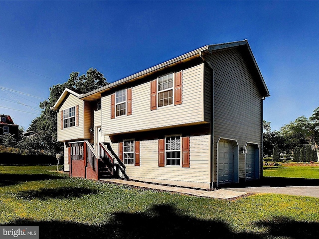 view of front of property with a garage and a front lawn