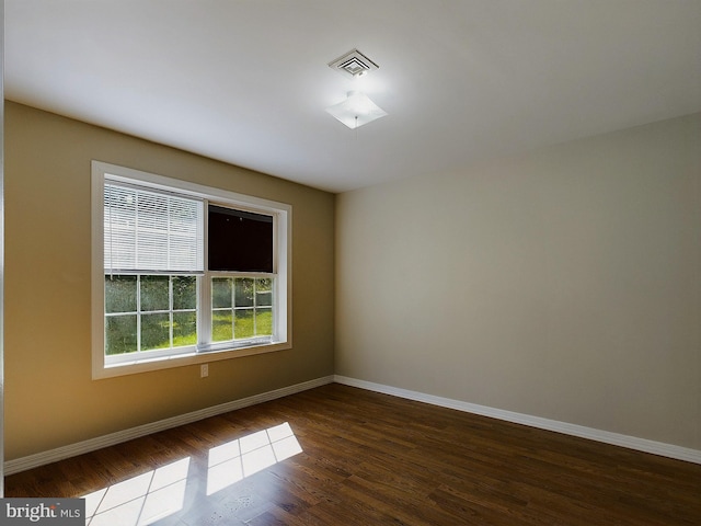 unfurnished room featuring dark hardwood / wood-style floors