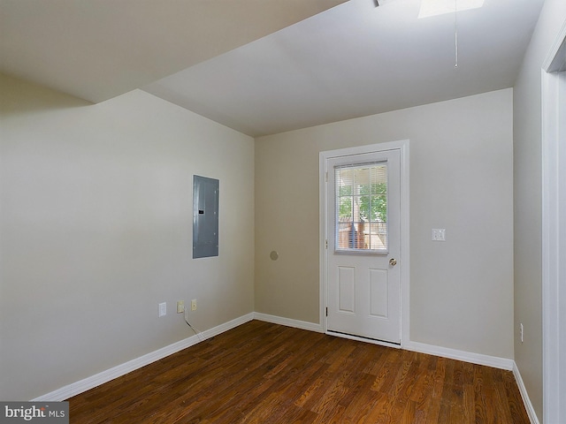 interior space featuring electric panel and dark wood-type flooring