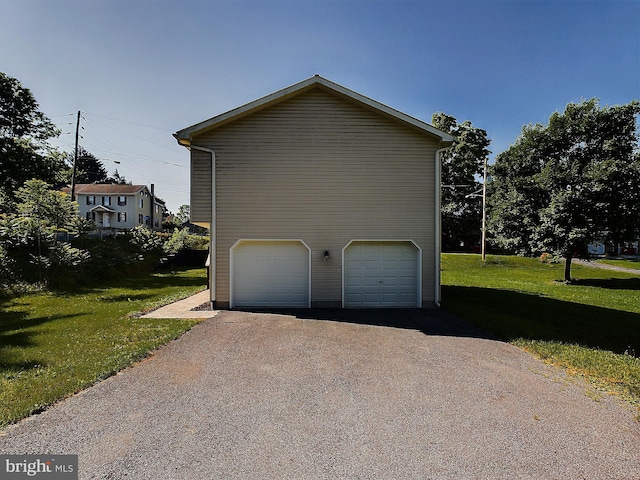 view of side of property featuring a yard and a garage