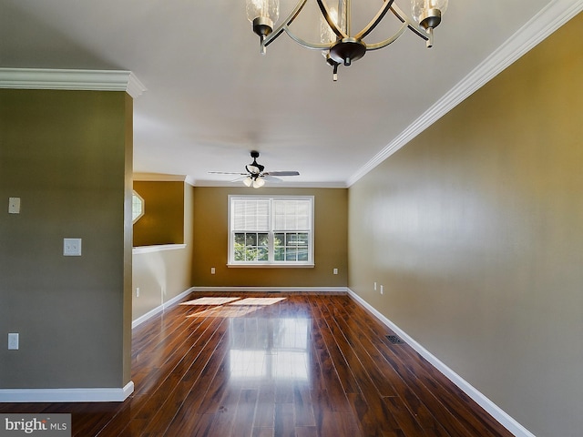 empty room with ceiling fan with notable chandelier, dark hardwood / wood-style flooring, and ornamental molding