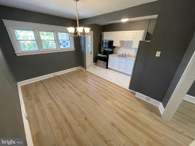 kitchen featuring pendant lighting, an inviting chandelier, stainless steel electric stove, white cabinets, and light hardwood / wood-style flooring