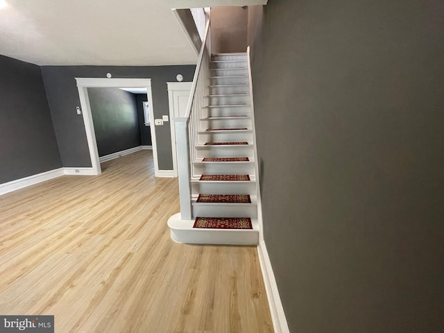 stairs with hardwood / wood-style flooring