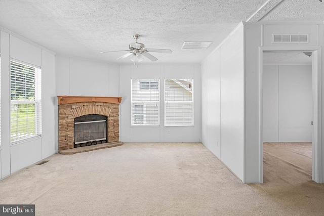 unfurnished living room featuring a fireplace, light carpet, plenty of natural light, and ceiling fan