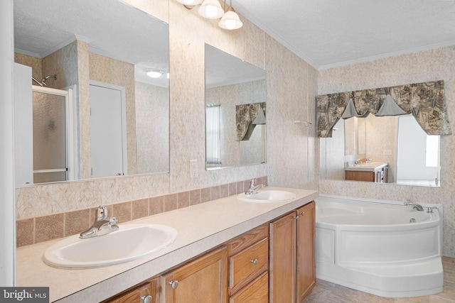 bathroom featuring plus walk in shower, vanity, a textured ceiling, and ornamental molding