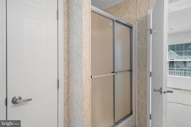 bathroom with a textured ceiling and walk in shower