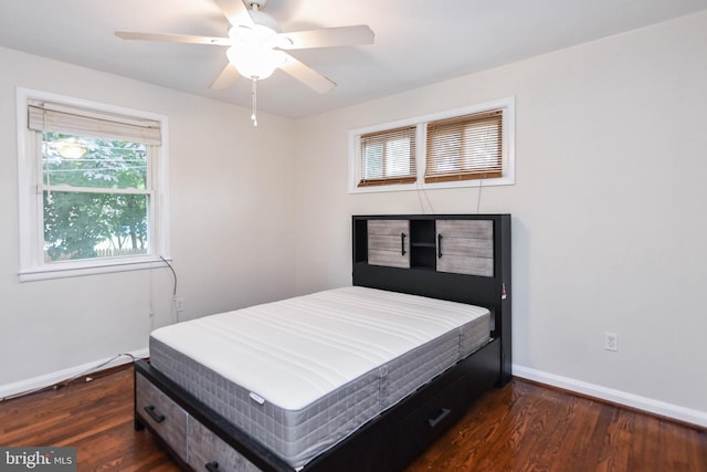 bedroom with dark hardwood / wood-style flooring and ceiling fan