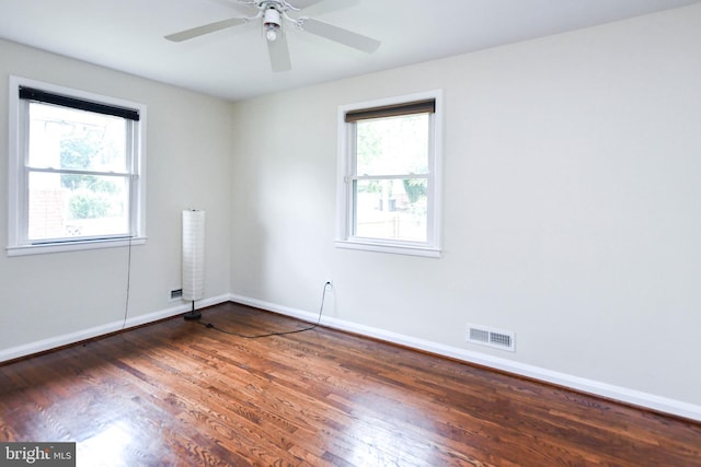 empty room featuring ceiling fan and dark hardwood / wood-style floors