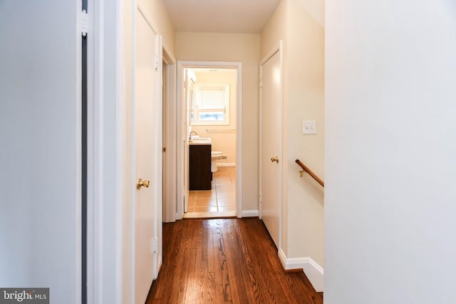 hallway with dark hardwood / wood-style flooring