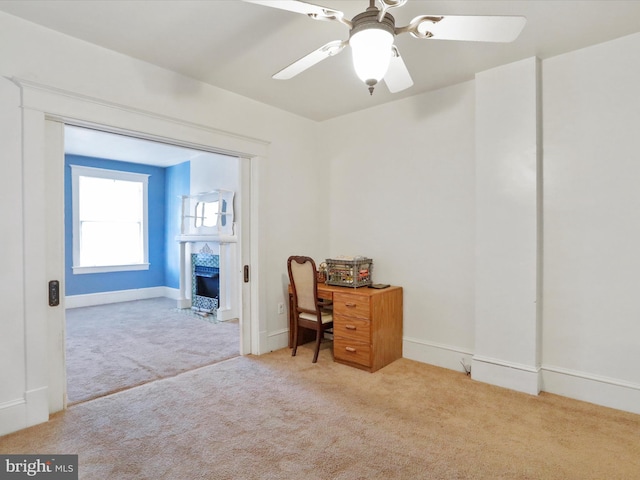 office featuring ceiling fan and light carpet