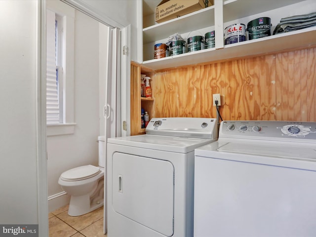 laundry area with light tile patterned floors and washing machine and clothes dryer